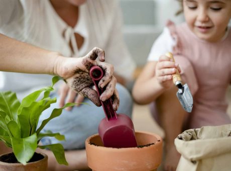 Kid DIY plant potting at home with mom