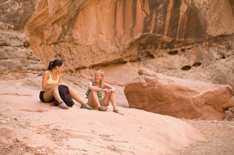 Rock climbers relaxing on boulder